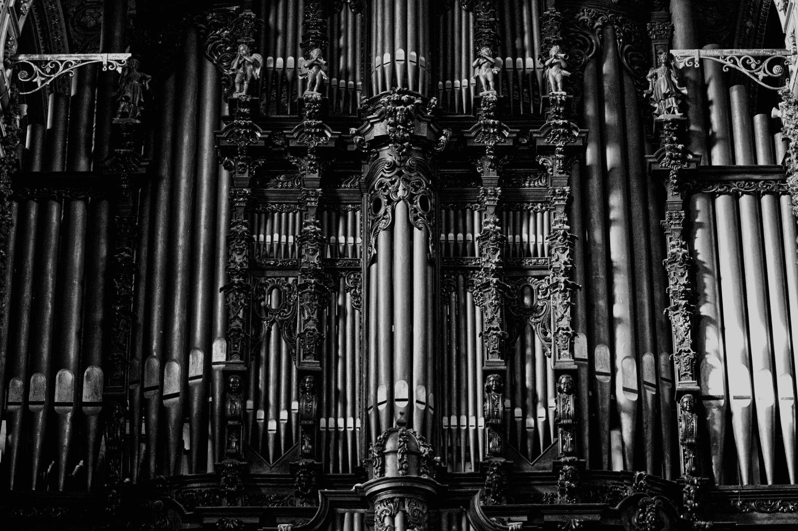 Ornate baroque pipe organ facade in black and white