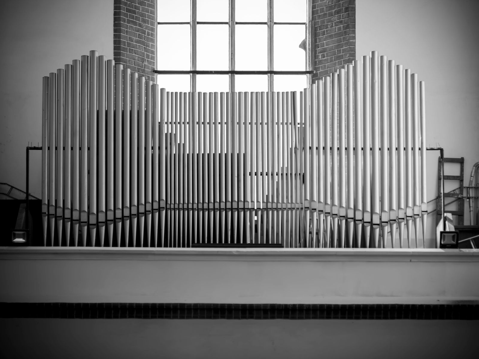 Symmetrical black and white photo of a pipe organ facade