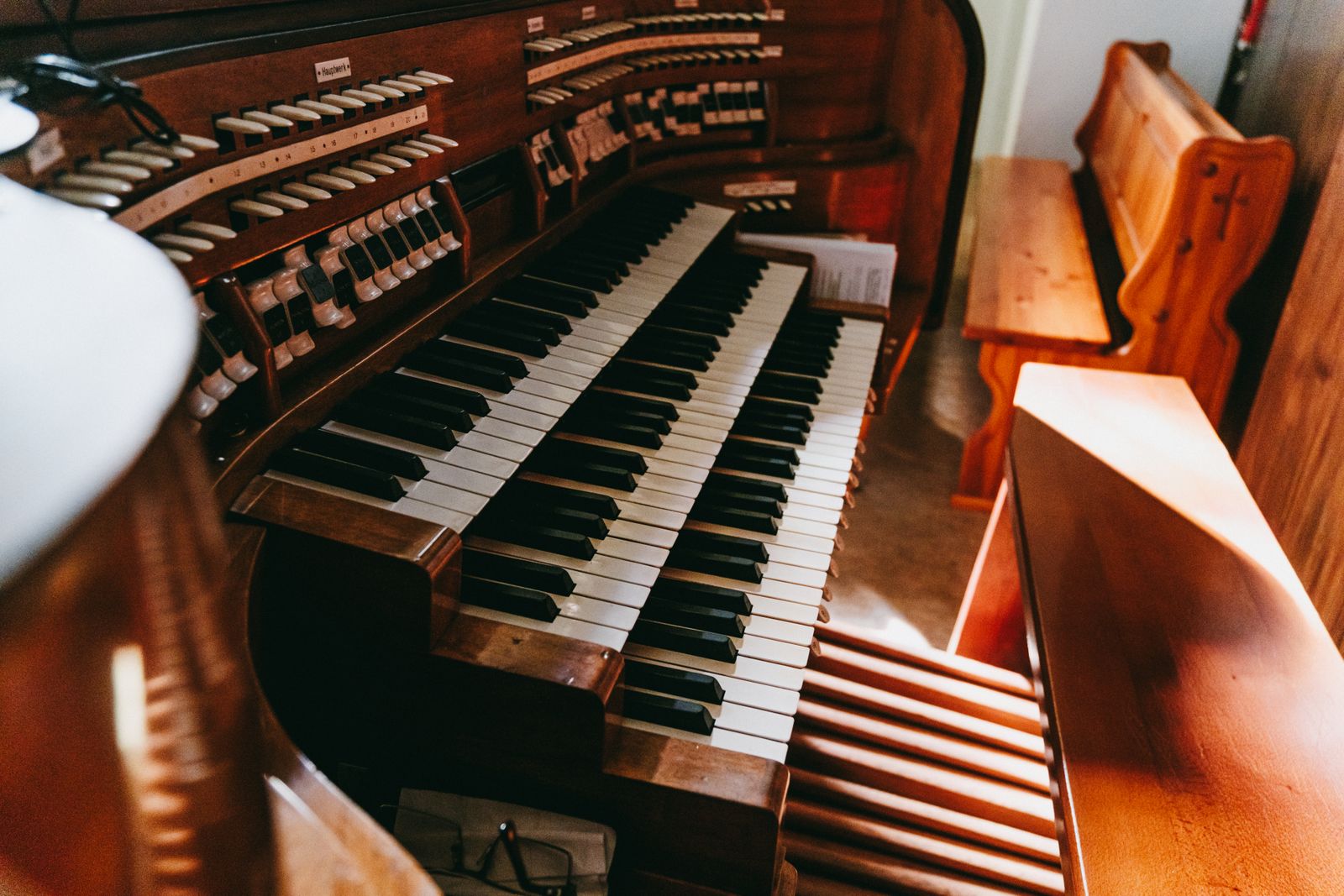 Hands on a pipe organ console, manuals and stops